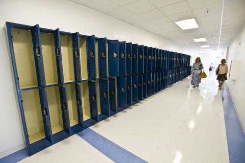 A hallway with many open lockers