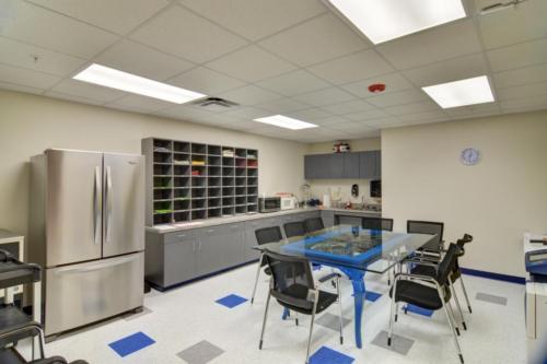 A teacher workroom with a large refrigerator