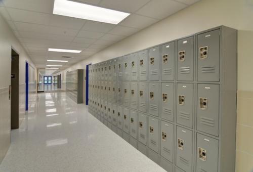 A hallway lined with gray lockers