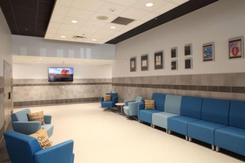 A sitting/waiting area with different shades of blue upholstered chairs