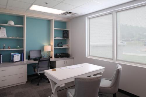 An administrator's office with a teal accent wall