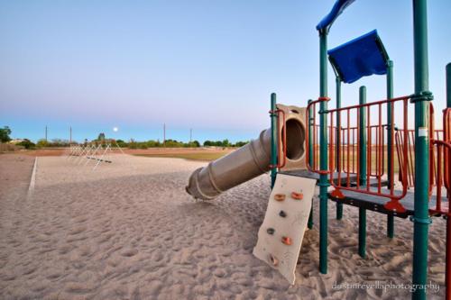 playground equipment with swings in background