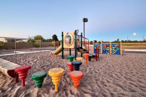 colorful playground equipment at sunset