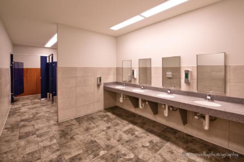 restroom with tiled floors and walls