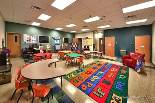 colorful classroom with a rug that features the letters of the alphabet