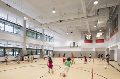 Students playing soccer inside the school gym