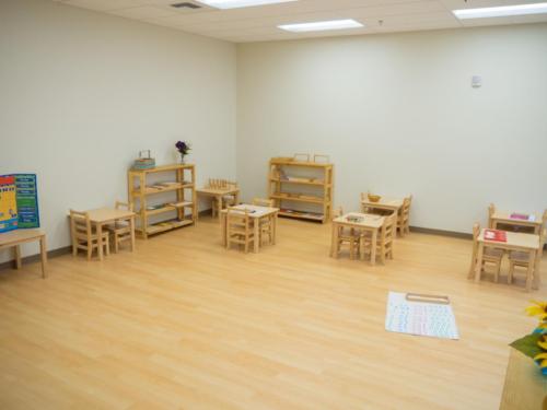 open classroom with wooden floors and furniture