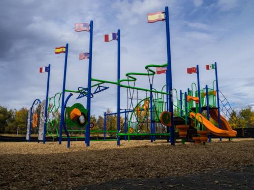 Wide shot of playground equipment with international flags