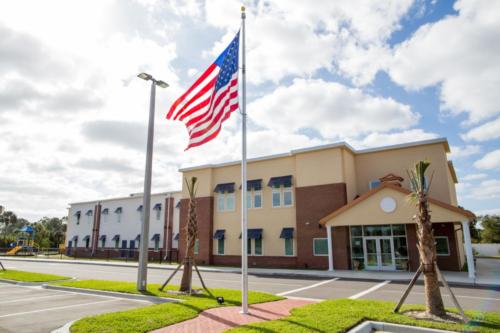 School exterior and a U.S. flag