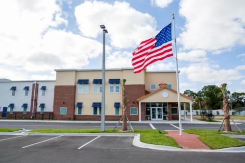 School entrance and a U.S. flag