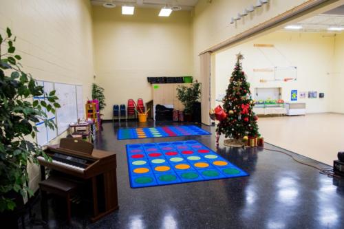 View from the stage area with colorful rugs and a Christmas tree