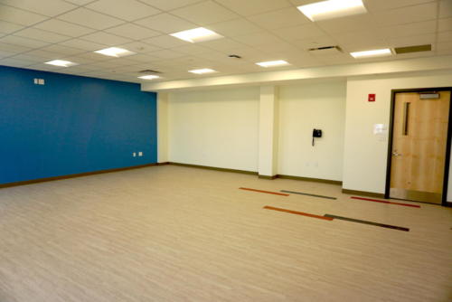 Classroom with wooden floors and a blue wall