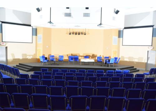 School auditorium with blue chairs on the stage