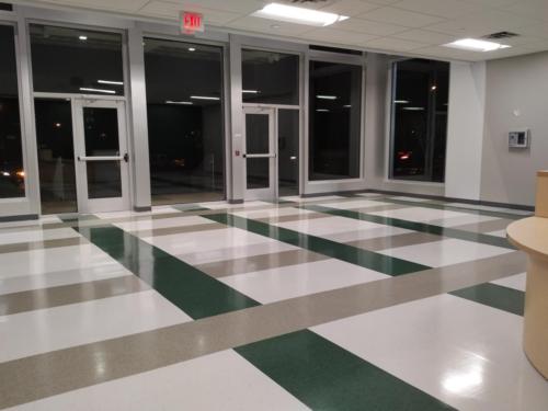 The school lobby with green and cream tile floor