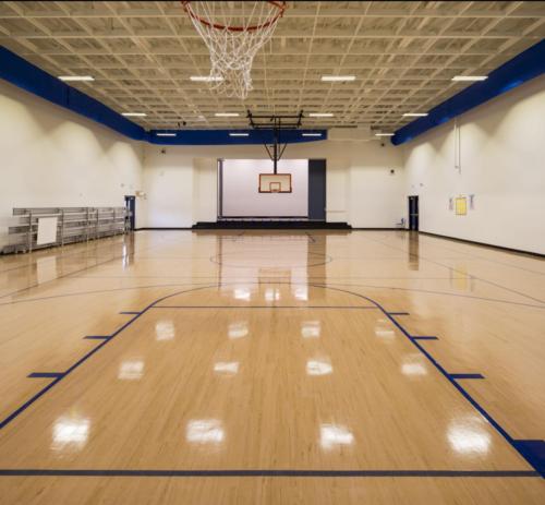 View of the school gym from under a basketball hoop