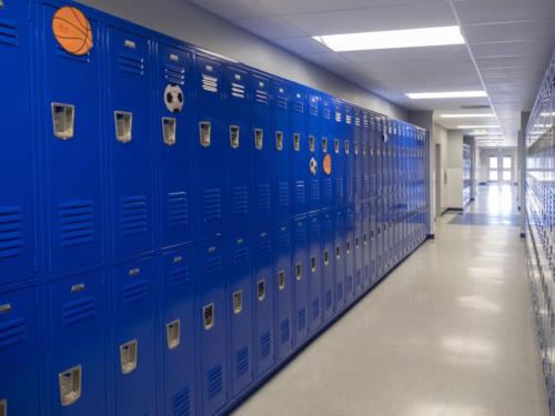 A hallway with bright blue lockers