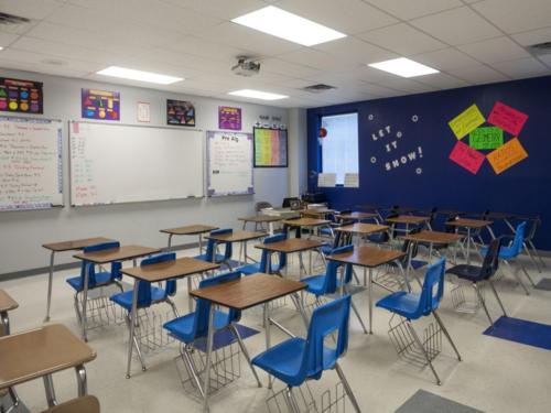 Wooden desks lined in a grid inside a math classroom