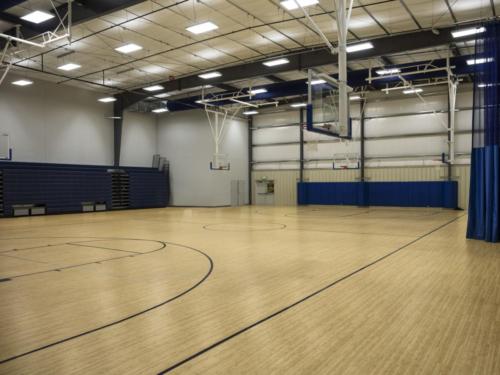 School gym with 6 separate basketball hoops