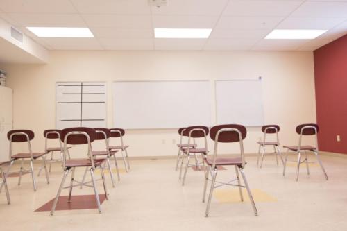 A classroom with metal chairs with no desks