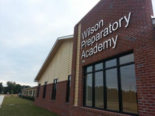 Closeup view of the exterior wall with Wilson Preparatory Academy sign