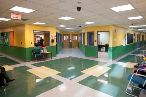School lobby with green and yellow walls and tile floors