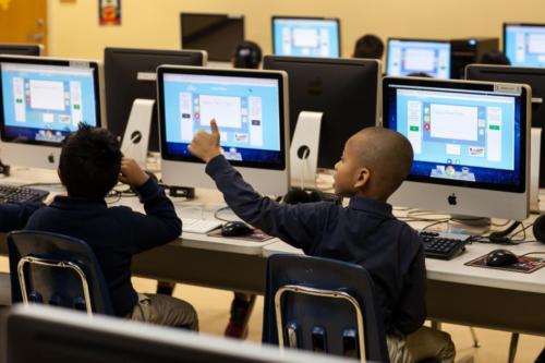 A student giving a thumbs up in the computer lab