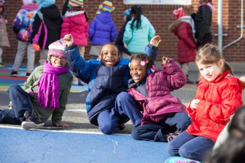 Students outside playing and smiling