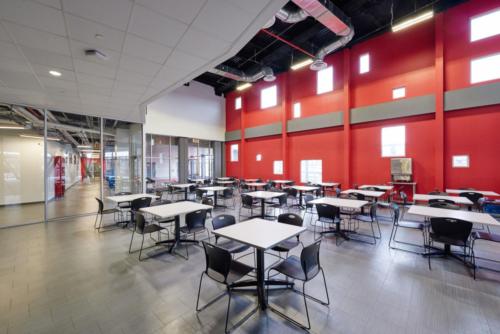 A cafeteria or common area with many square tables