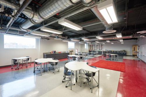 Very large and open classroom with uniquely-shaped tables