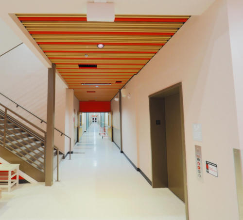 School hallway with a colorful, striped ceiling