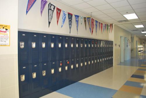 A bank of lockers with pennants hanging above them