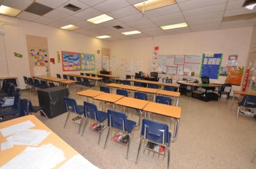 A classroom with desks arranged in lines of four