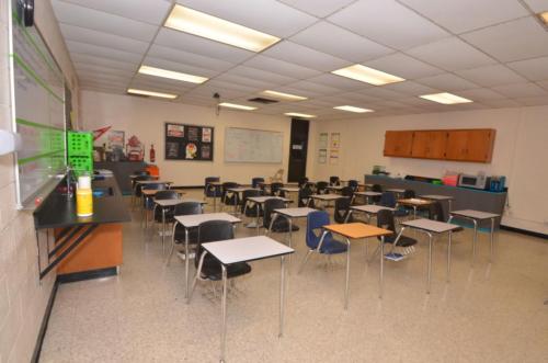 A classroom with student chair/desk combos