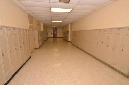 A school hallway lined with tan lockers