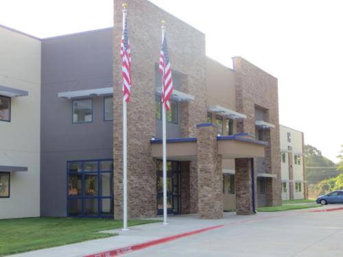 Two flagpoles outside the entrance of Cumberland Middle School