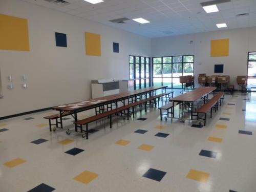School cafeteria with black and yellow tiles on the floor and walls