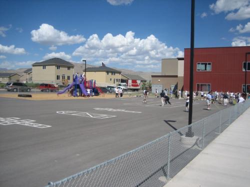 The blacktop and playground area behind the school