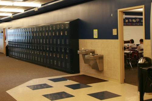 A bank of lockers next to a drinking fountain
