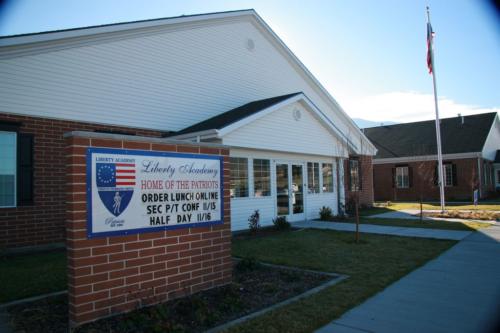The entrance to Liberty Academy with a sign communicating dates for parent teacher conferences