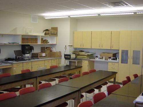 A science classroom with long black tables