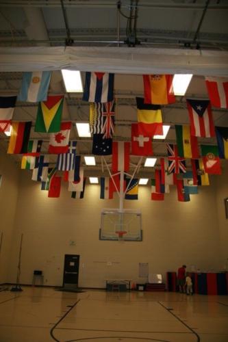 Flags from dozens of countries hanging from the ceiling of the school gym