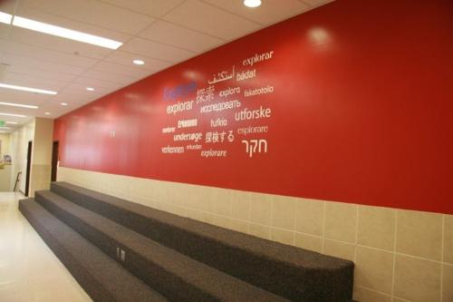 A wall with the word "explore" painted in many different languages