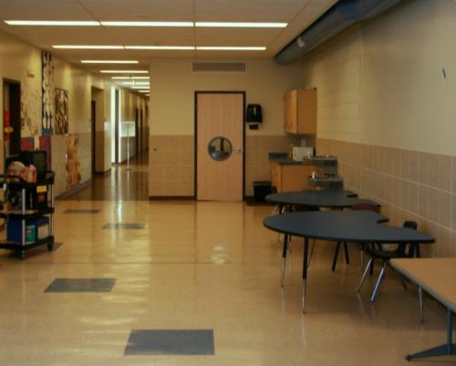 A hallway with semicircular tables along the wall