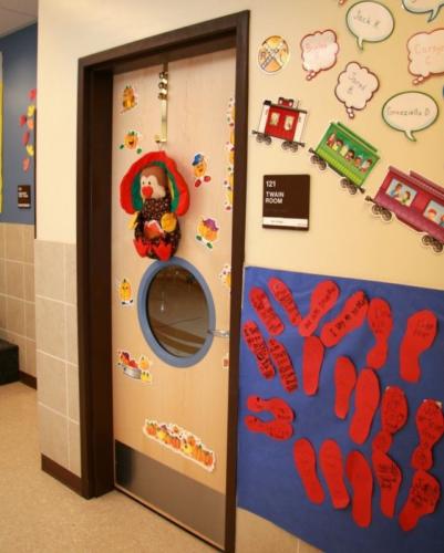 A classroom door decorated with a toy stuffed turkey