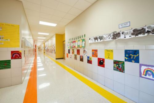 A bright hallway with student art hanging on the walls