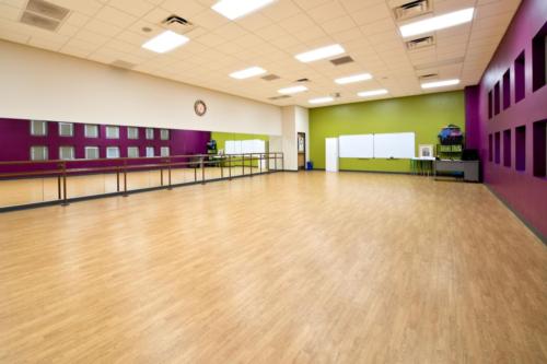 A dance studio with purple and green walls