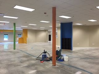 An open space under construction with colorful walls and pillars