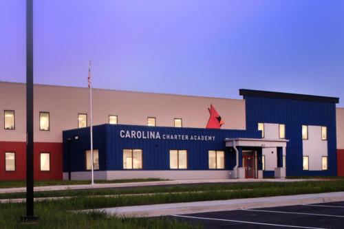 Exterior image of Carolina Charter Academy with flag up