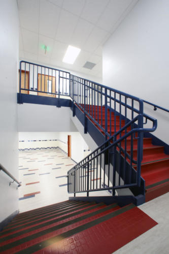 Image of staircase leading to upper hallway at CCA